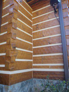A corner of a building with wood paneling on the side.