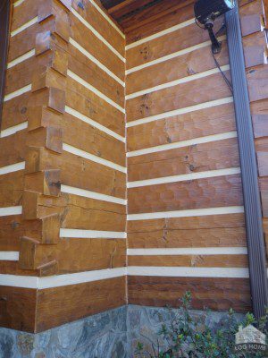 A corner of a building with wood paneling.