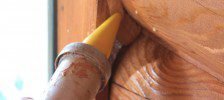 A person holding a wooden stick with something in it