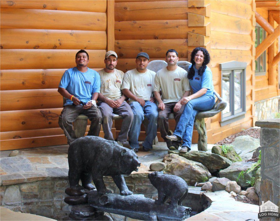A group of people sitting in front of a bear statue.