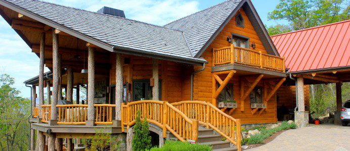 A wooden house with stairs going up to it.