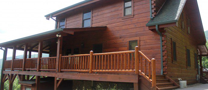 A large wooden house with steps leading to the front.