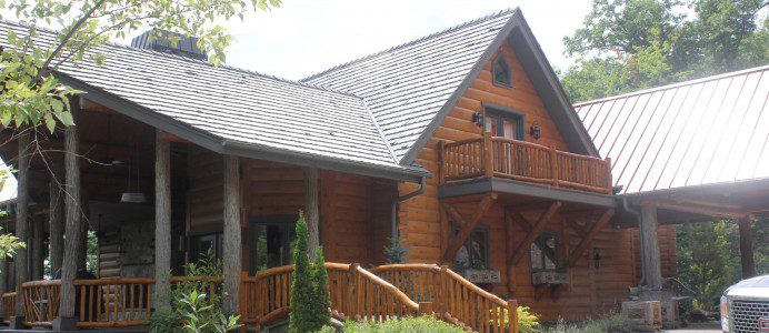 A large wooden house with a porch and stairs.