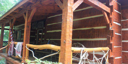 A log cabin with a wooden roof and some logs