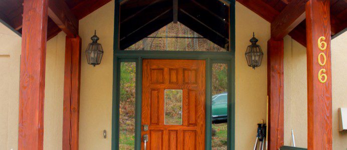 A welcoming wooden porch with a bench, perfect for an inviting entry.