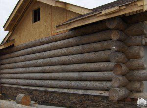 A wooden log cabin under construction.